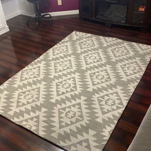 Grey and White aztec print rug.